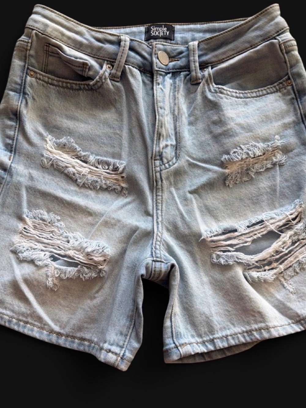 Women’s light wash distressed denim shorts by Simple Society. Size 1.